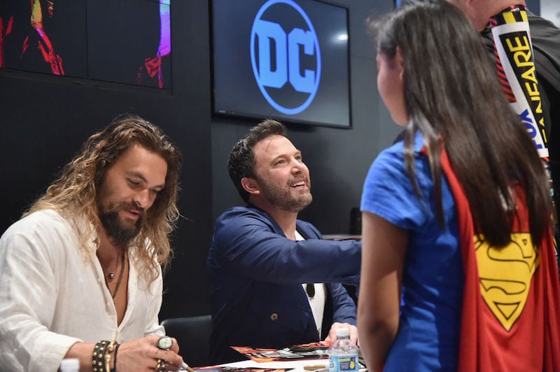Jason Momoa sits next to Ben Affleck while talking to fans Jason Momoa sits next to Ben Affleck while talking to fans