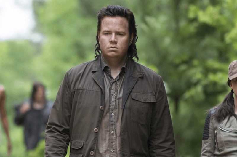 Eugene Porter walking and staring downward at the ground. 