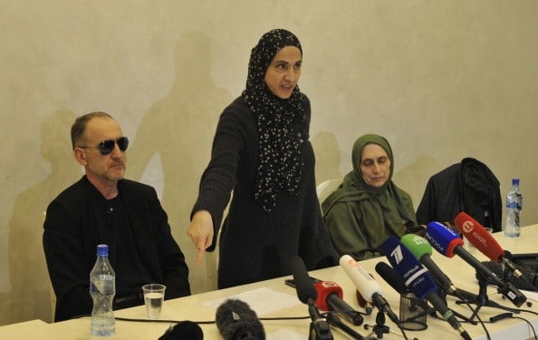 the family of Boston marathon bombers give a press conference behind a row of microphones the family of Boston marathon bombers give a press conference behind a row of microphones