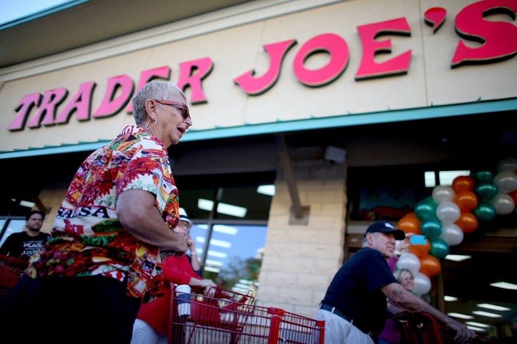 Shoppers lineup as they wait for the grand opening of a Trader Joe's on October 18, 2013 in Pinecrest, Florida. Trader Joe's opened its first store in South Florida where shoppers can now take advantage of the California grocery chains low-cost wines and unique items not found in other stores. About 80 percent of what they sell is under the Trader Joe's private label. (Photo by Joe Raedle/Getty Images)