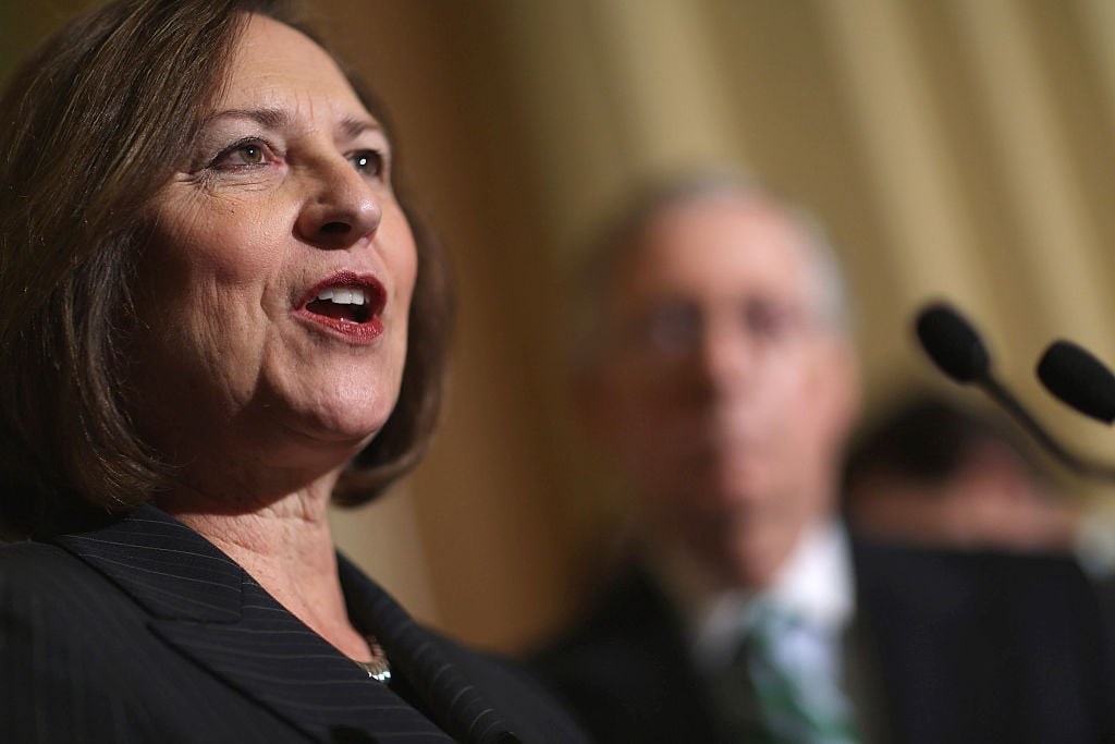 Deb Fischer speaks facing right, with another man in the background Deb Fischer speaks facing right, with another man in the background