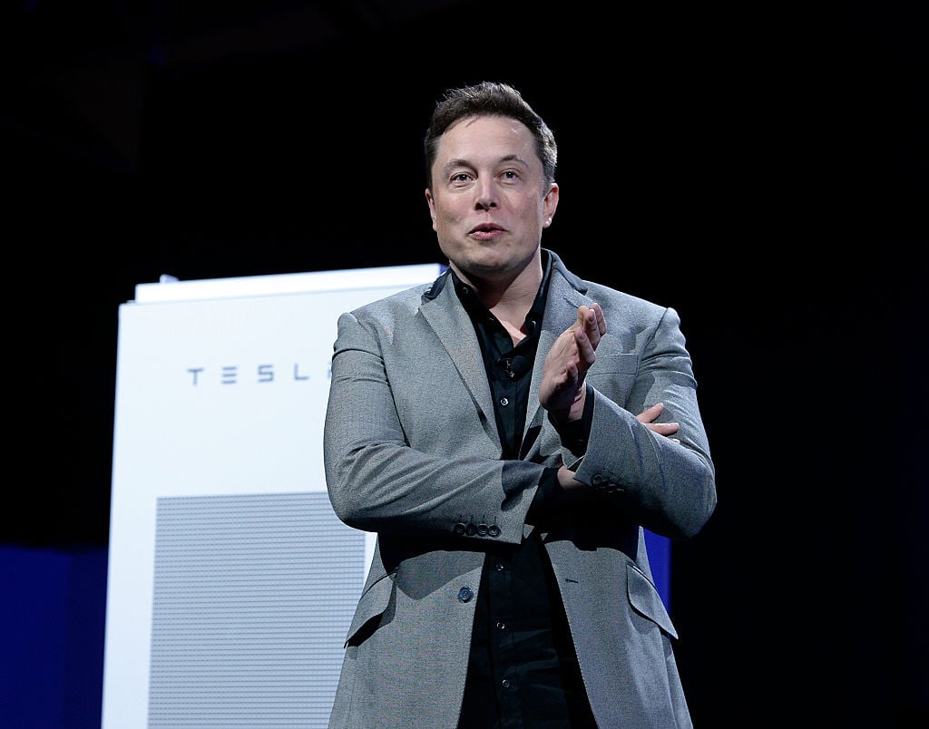 Elon Musk, CEO of Tesla, with a Powerpack unit the background