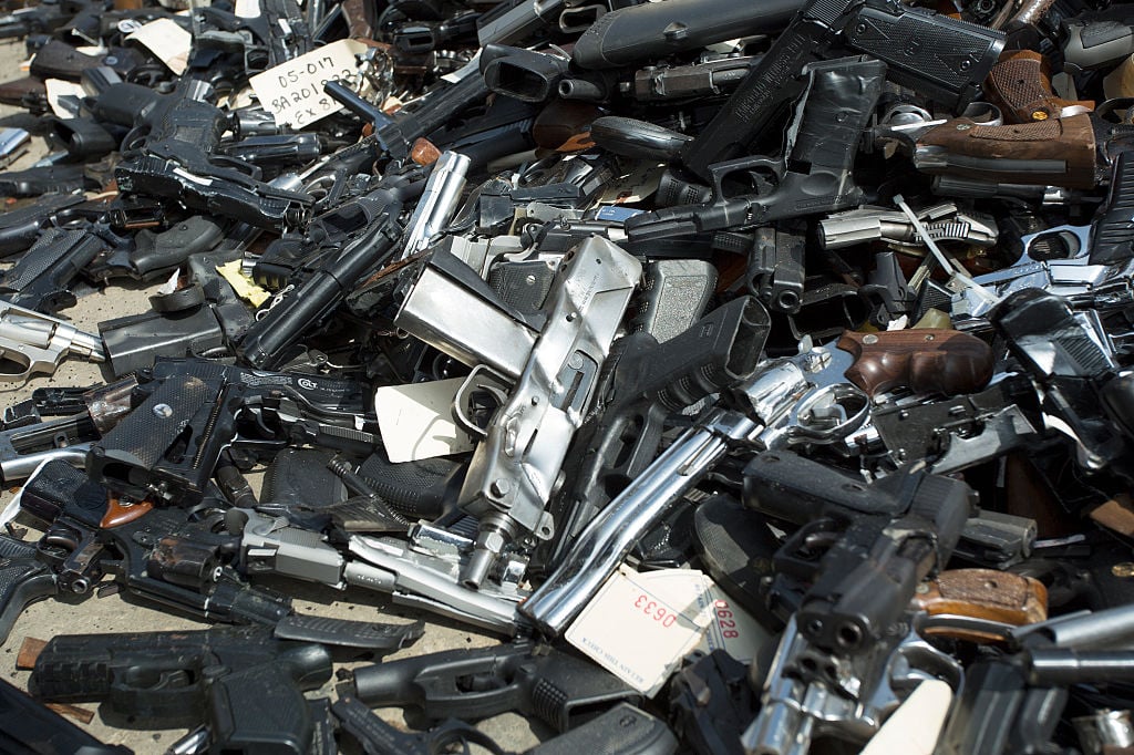 a pile of surrendered guns at an event for surrendering them