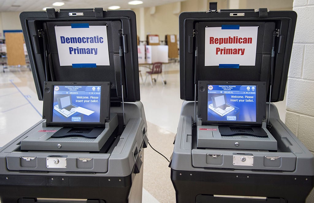 two voting machines, one with Republican and one with Democrat signs on them