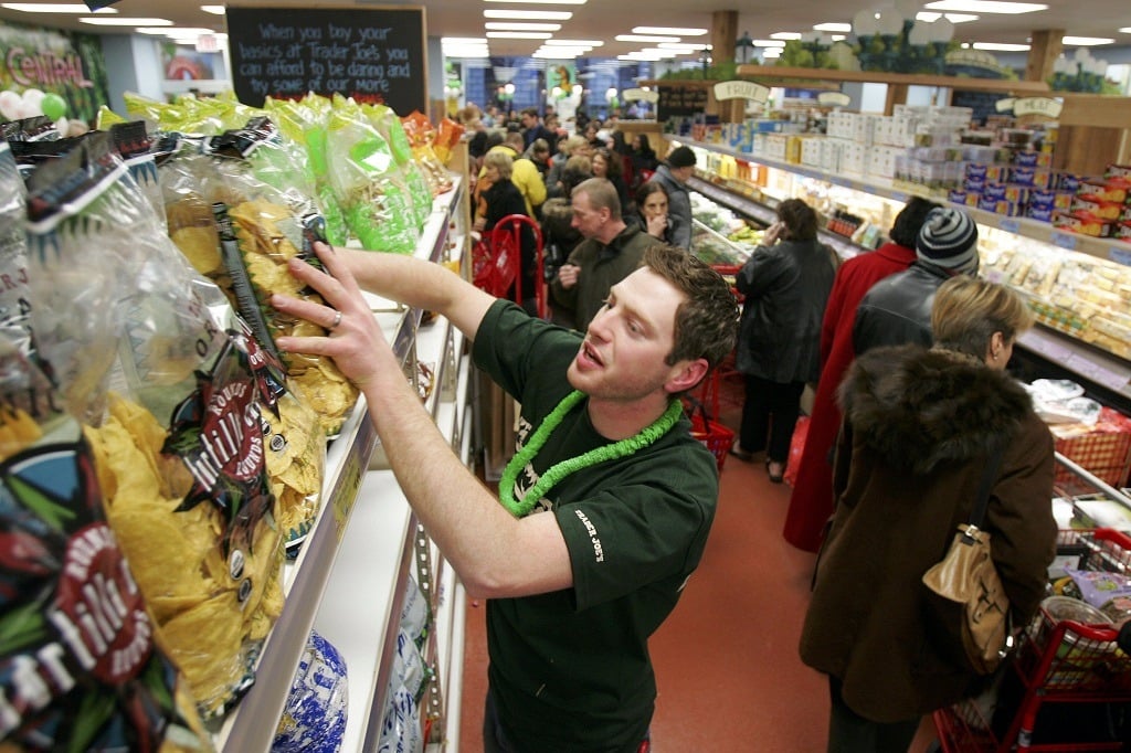 Jason Baglin restocks chips as shoppers line up inside Trader Joe's for the grand opening on 14th Street on March 17, 2006 in New York City. Trader Joe's, a specialty retail grocery store, has more than 200 stores in 19 states. (Photo by Michael Nagle/Getty Images)
