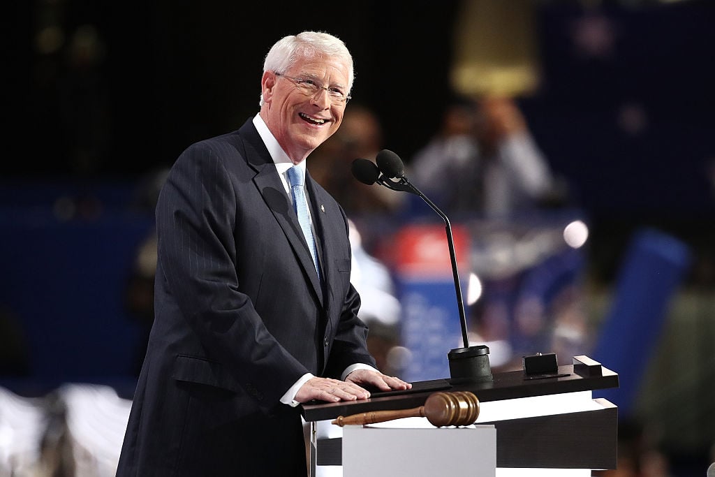 Roger Wicker at a white podium in a dark suit Roger Wicker at a white podium in a dark suit