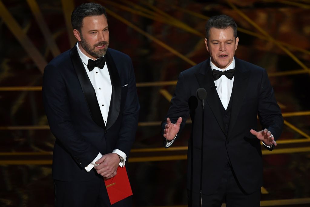 Ben Affleck and Matt Damon in tuxedos onstage Ben Affleck and Matt Damon in tuxedos onstage