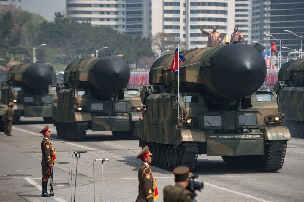 To large missile launch vehicles are paraded down the street in PyongYang