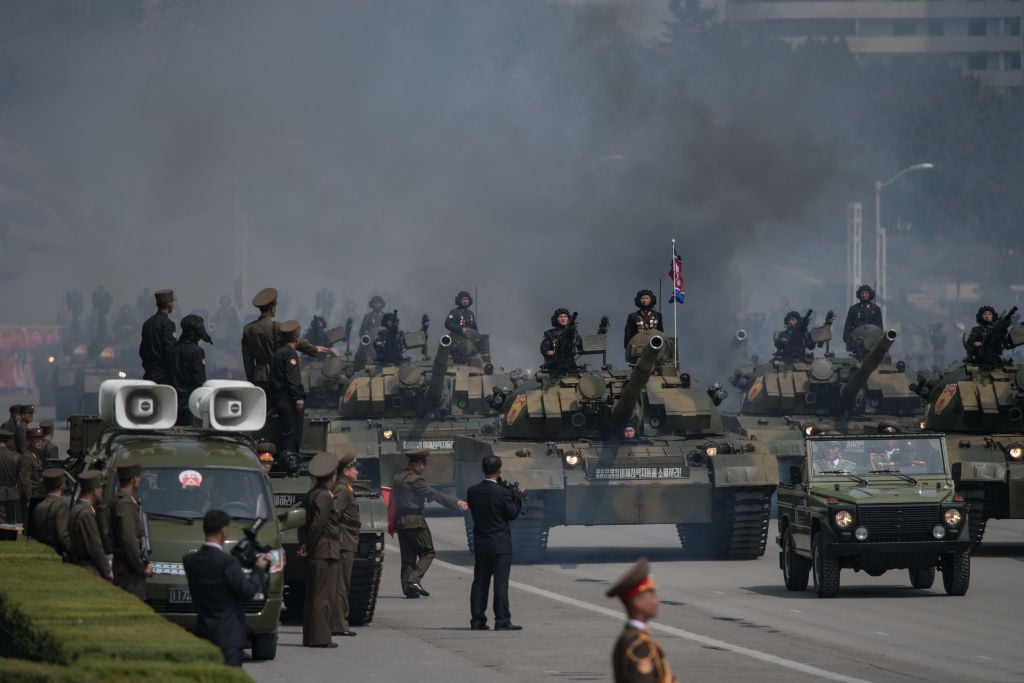 north korea military soldiers with tanks and smoke