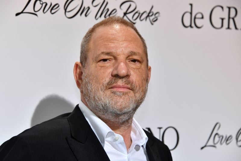 Harvey Weinstein in a dark suit and white shirt against a white and black background