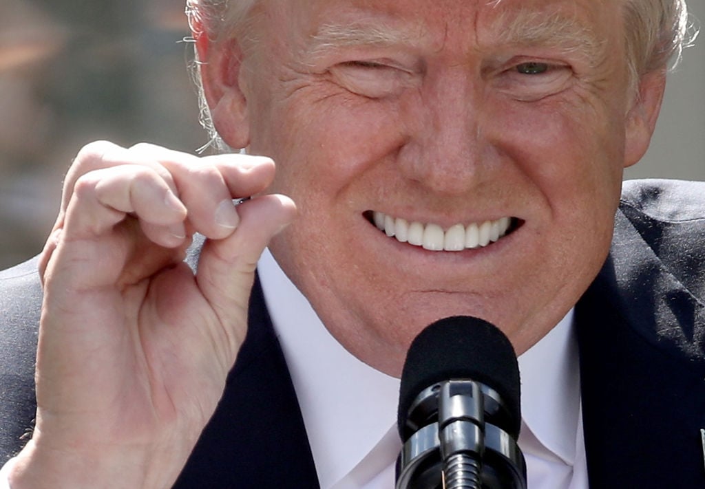 Donald Trump squinting and pinching his fingers together Donald Trump squinting and pinching his fingers together