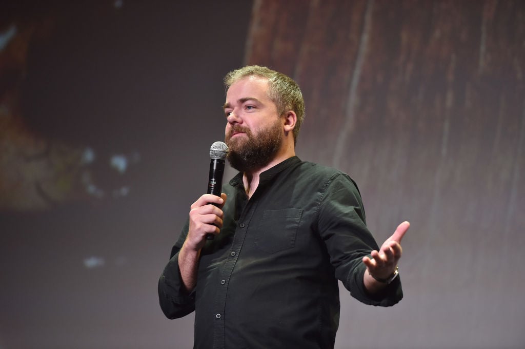 David F. Sandberg speaks into a microphone on stage. David F. Sandberg speaks into a microphone on stage.