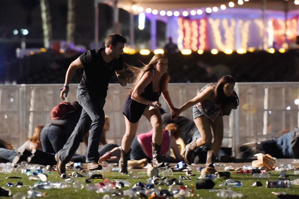 people running and holding hands at Las vegas shooting