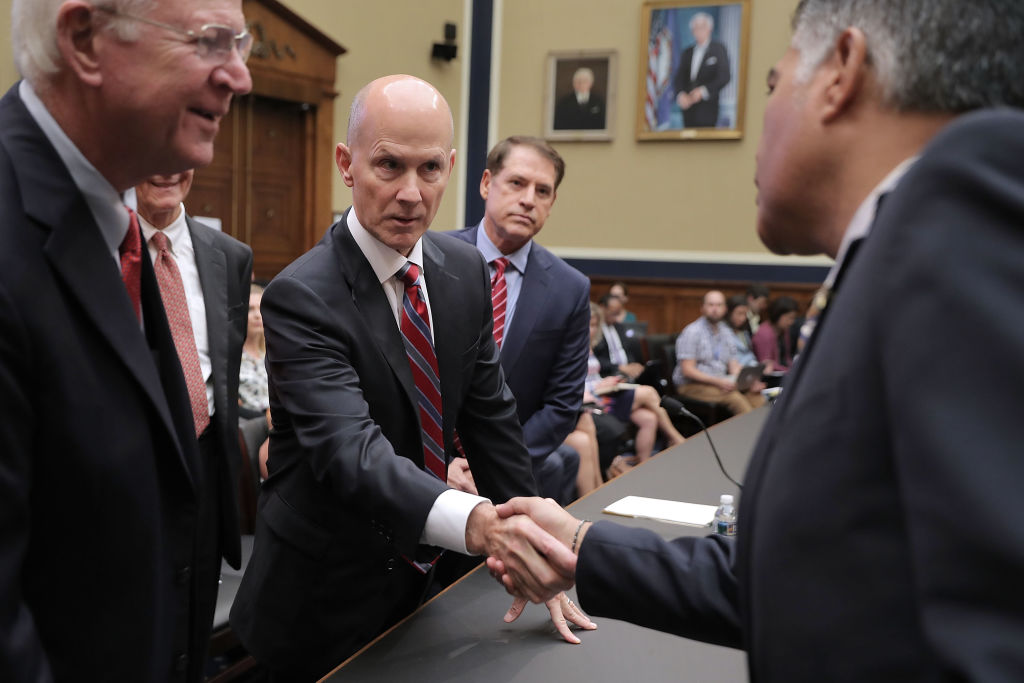 CEO shakes politicians' hands