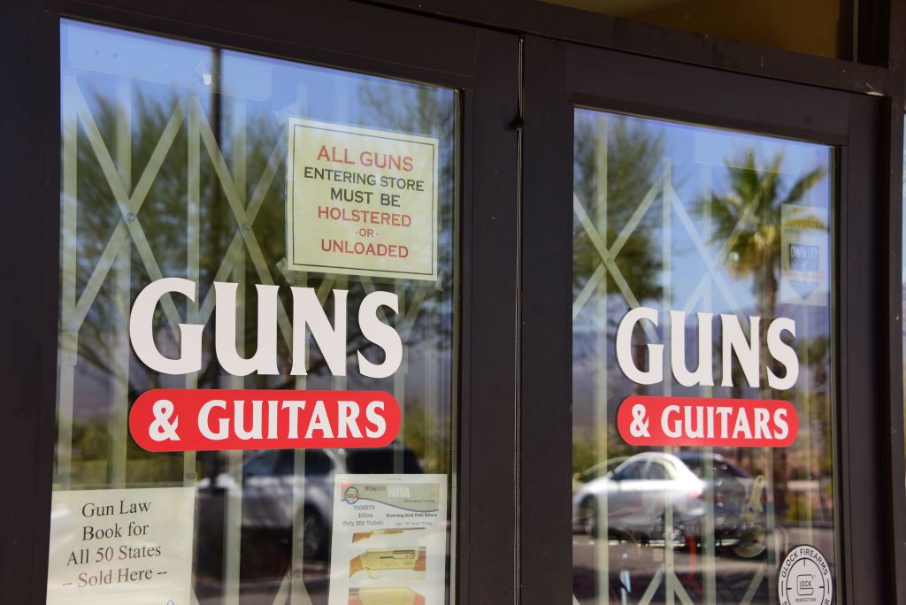 door to guns & guitars shop in white and red