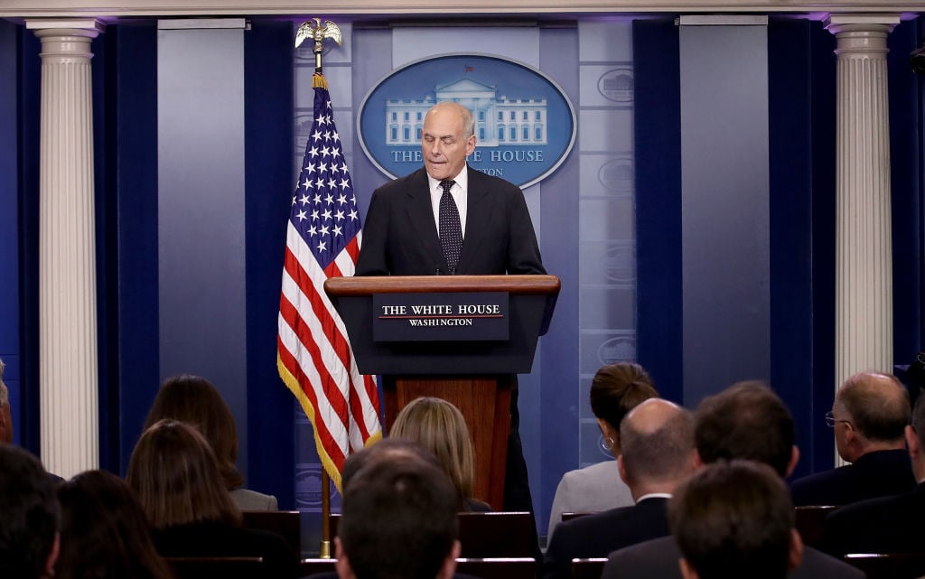 John Kelly talks to the white house press pool in a dark suit John Kelly talks to the white house press pool in a dark suit