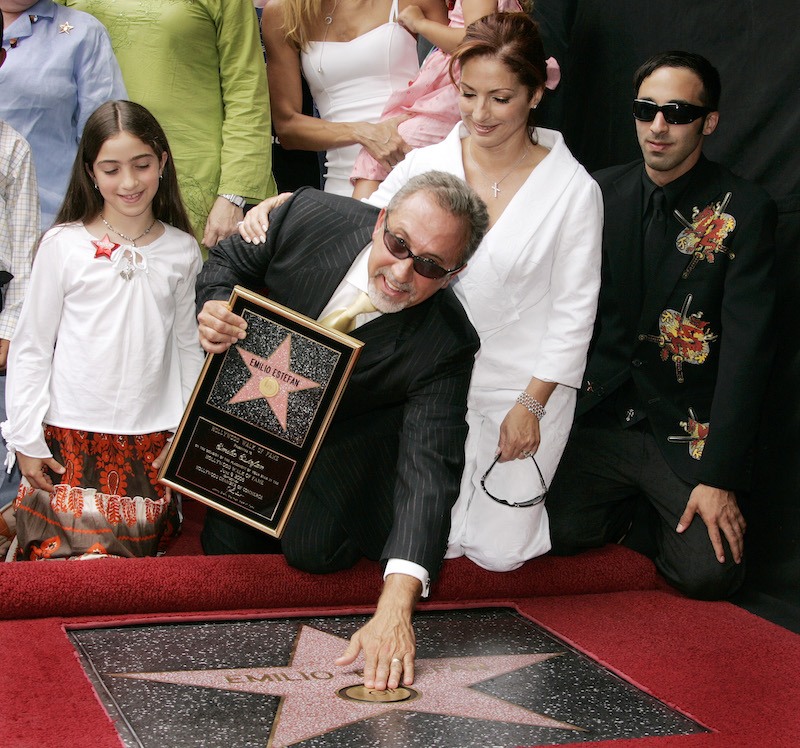 Emilio Estefan and his family pose in front of his star.
