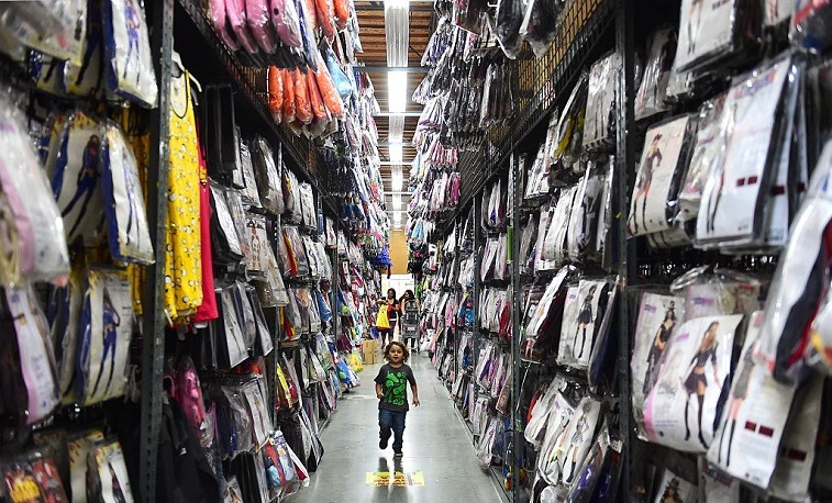 Child runs down costume aisle Child in Halloween aisle