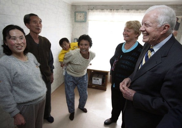 Jimmy Carter (R) and former Prime Minister of Norway Gro Brundtland (2nd R) chat with a family during a house visit on April 27, 2011, in Pyongsong, North Korea Jimmy Carter (R) and former Prime Minister of Norway Gro Brundtland (2nd R) chat with a family during a house visit on April 27, 2011, in Pyongsong, North Korea