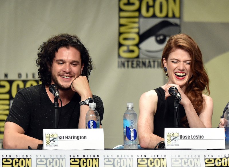 Kit Harington and Rose Leslie sit together and speak while on a Comic-Con pane. 