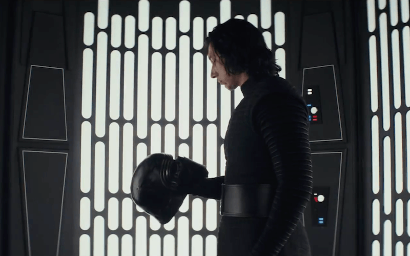 Kylo Ren in Star Wars: The Last Jedi staring at his helmet. 