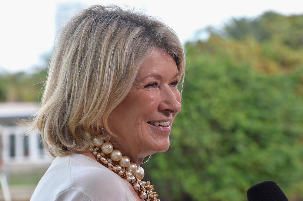 Martha Stewart smiling as she answers interview questions into a microphone.