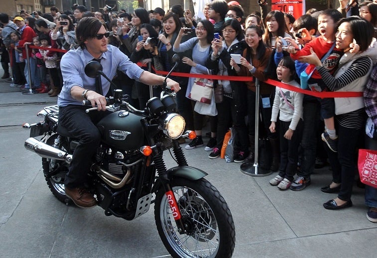 Norman Reedus rides a motorcycle