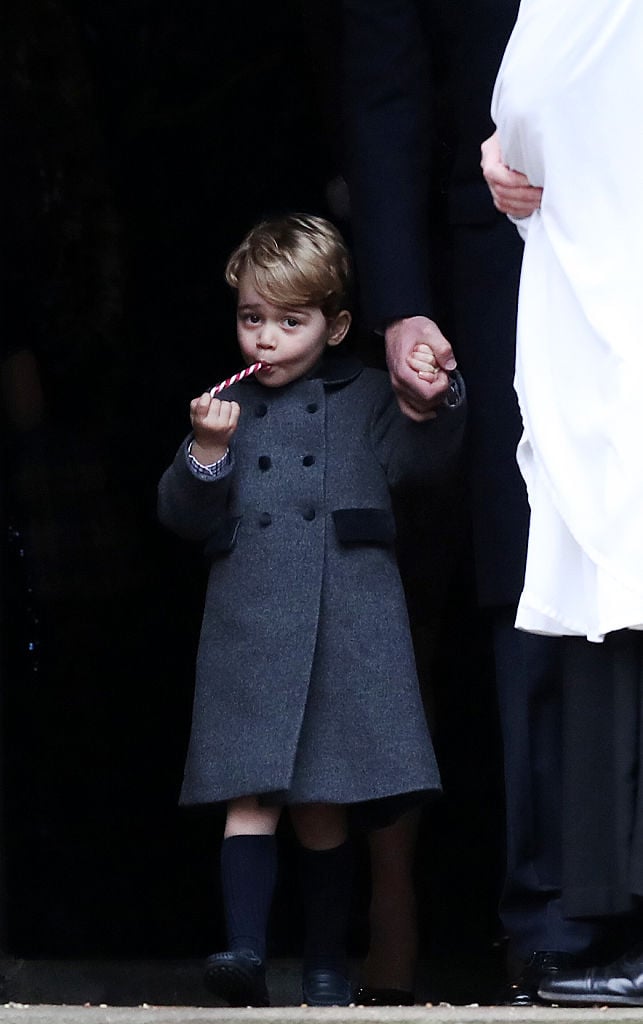 Prince George of Cambridge eats a sweet.