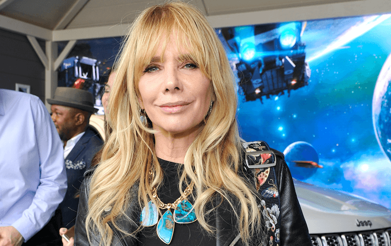 Rosanna Arquette smiles in a colorful jacket and necklaces. Rosanna Arquette smiles in a colorful jacket and necklaces.
