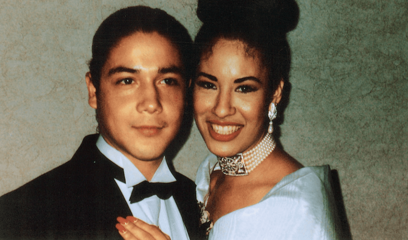 Selena and Chris Perez posing together and smiling. 