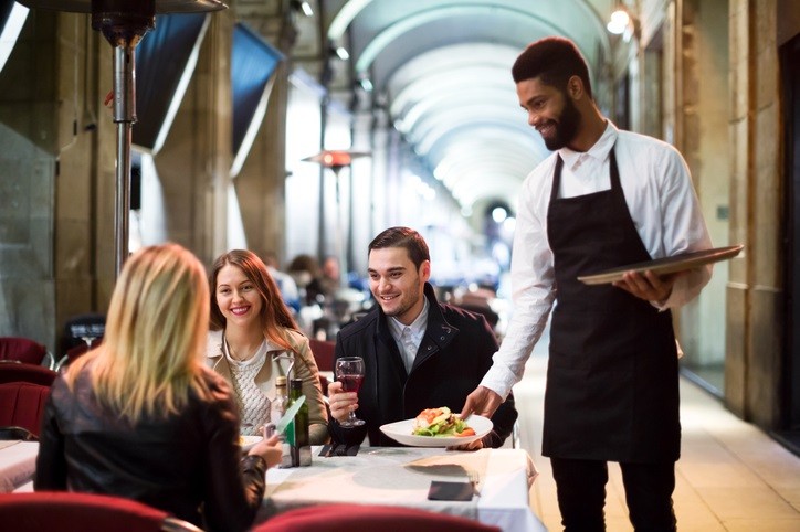 Waiter serving table on the terrace