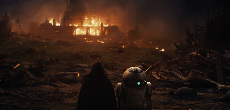 A building in the distance is on fire as two characters watch from afar among piles of rubble. A building in the distance is on fire as two characters watch from afar among piles of rubble.