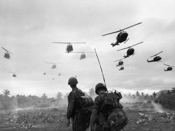 The second wave of combat helicopters of the 1st Air Cavalry Division fly over an RTO and his commander on an isolated landing zone The second wave of combat helicopters of the 1st Air Cavalry Division fly over an RTO and his commander on an isolated landing zone