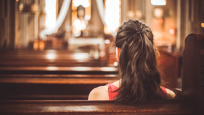 A woman sitting in a Christian church