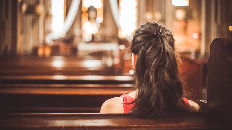 A woman sitting in a Christian church A woman sitting in a Christian church