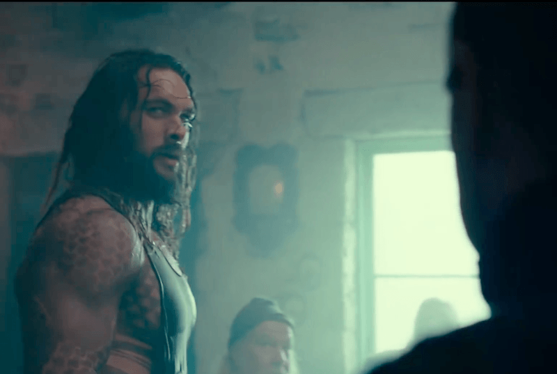Aquaman looks to the side to a shadowed figure Aquaman looks to the side to a shadowed figure