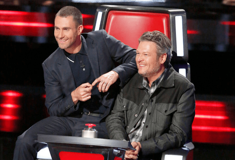 Adam Levine sits on Blake Shelton's chair on The Voice
