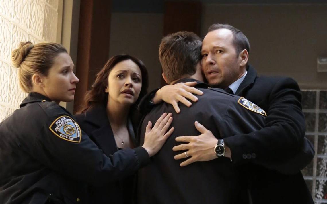 Two people hug two police officers Two people hug two police officers