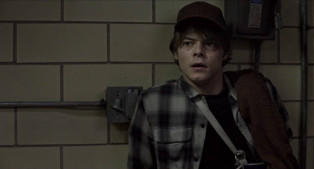 Charlie Heaton's Cannonball leans against a tile wall while wearing a flannel shirt Charlie Heaton's Cannonball leans against a tile wall while wearing a flannel shirt