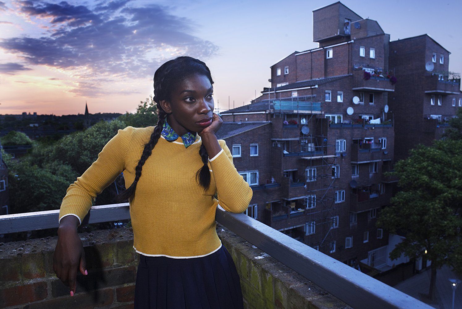 Michaela Coel stands on a balcony and leans her chin in her hand in Chewing Gum Michaela Coel stands on a balcony and leans her chin in her hand in Chewing Gum