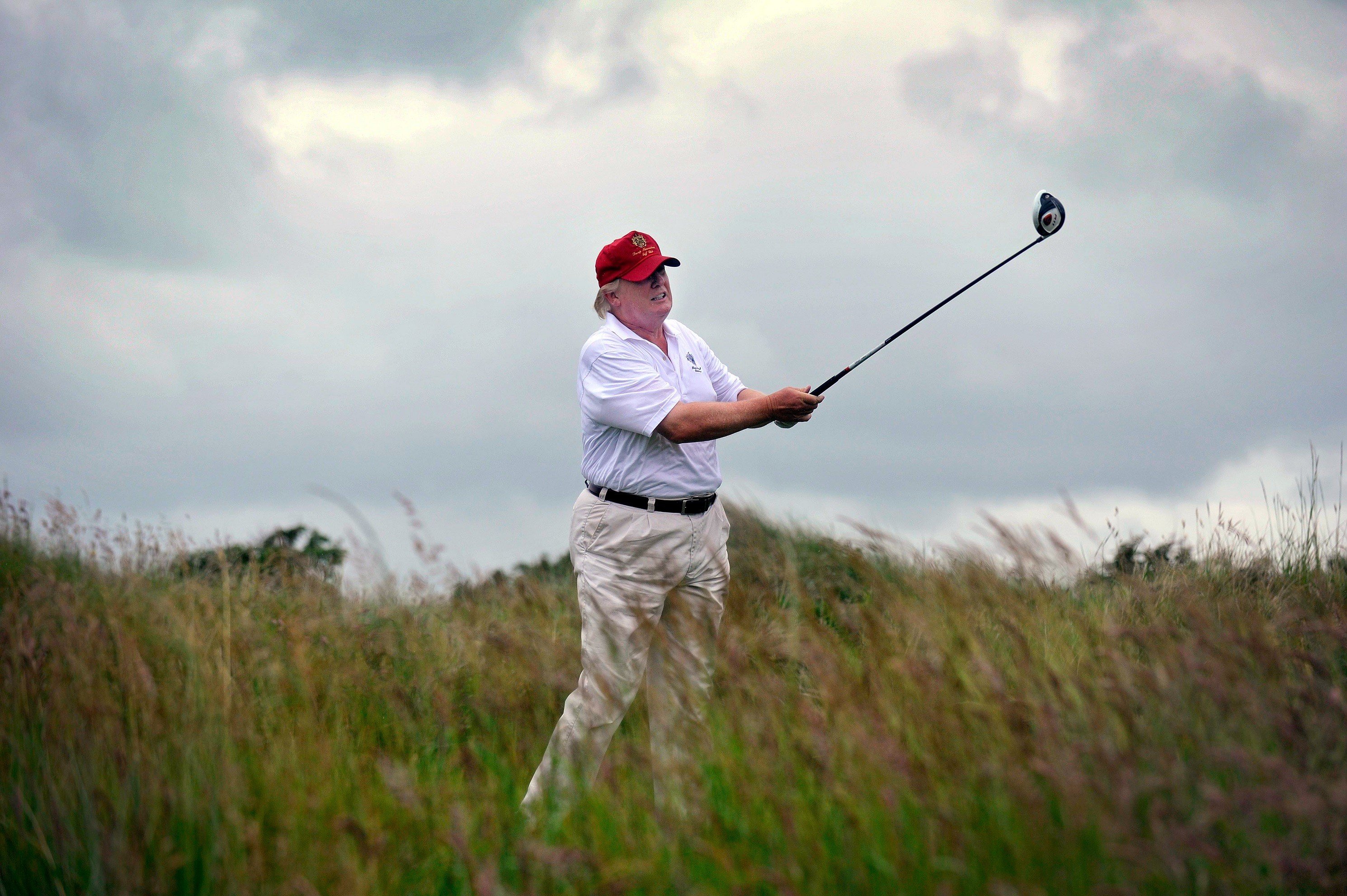 US tycoon Donald Trump plays a stroke as he officially opens his new multi-million pound Trump International Golf Links course in Aberdeenshire, Scotland, on July 10, 2012. Work on the course began in July 2010, four years after the plans were originally submitted. Donald Trump Golfing