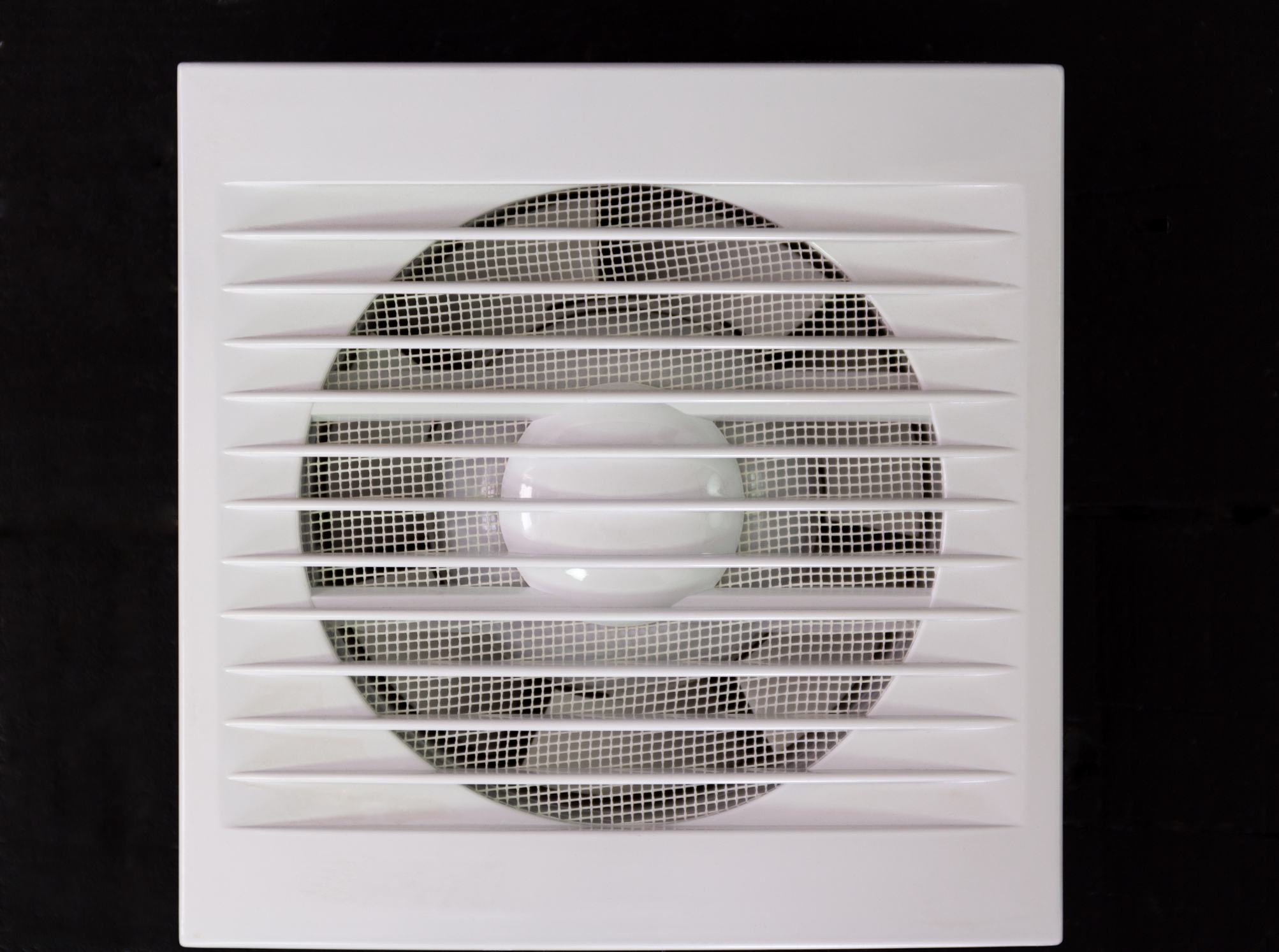 Wall electric extractor fan for bathroom. Closeup