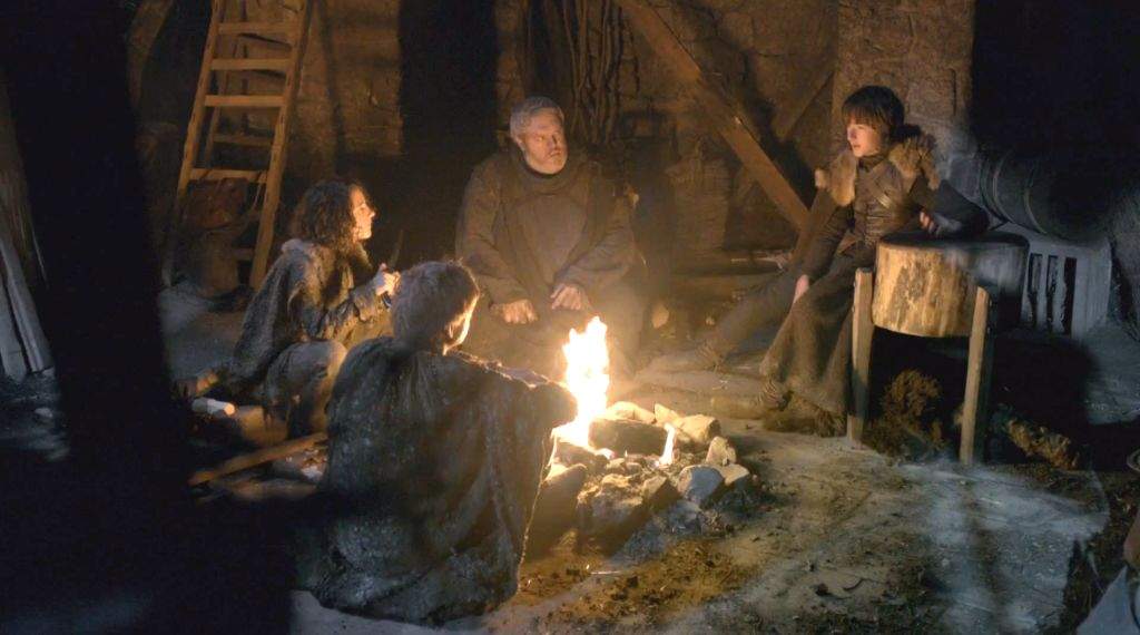 People sitting around a campfire on Game of Thrones.