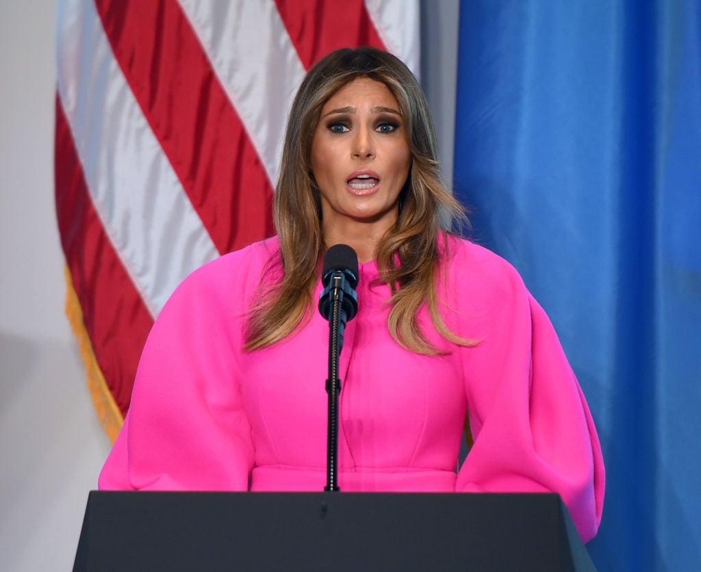 Melania Trump making a speech at a podium. Melania Trump making a speech at a podium.