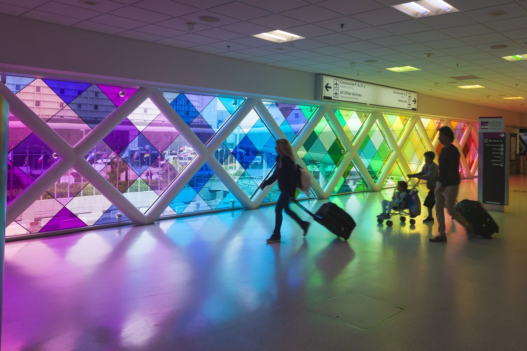 travelers walk in Miami International Airport