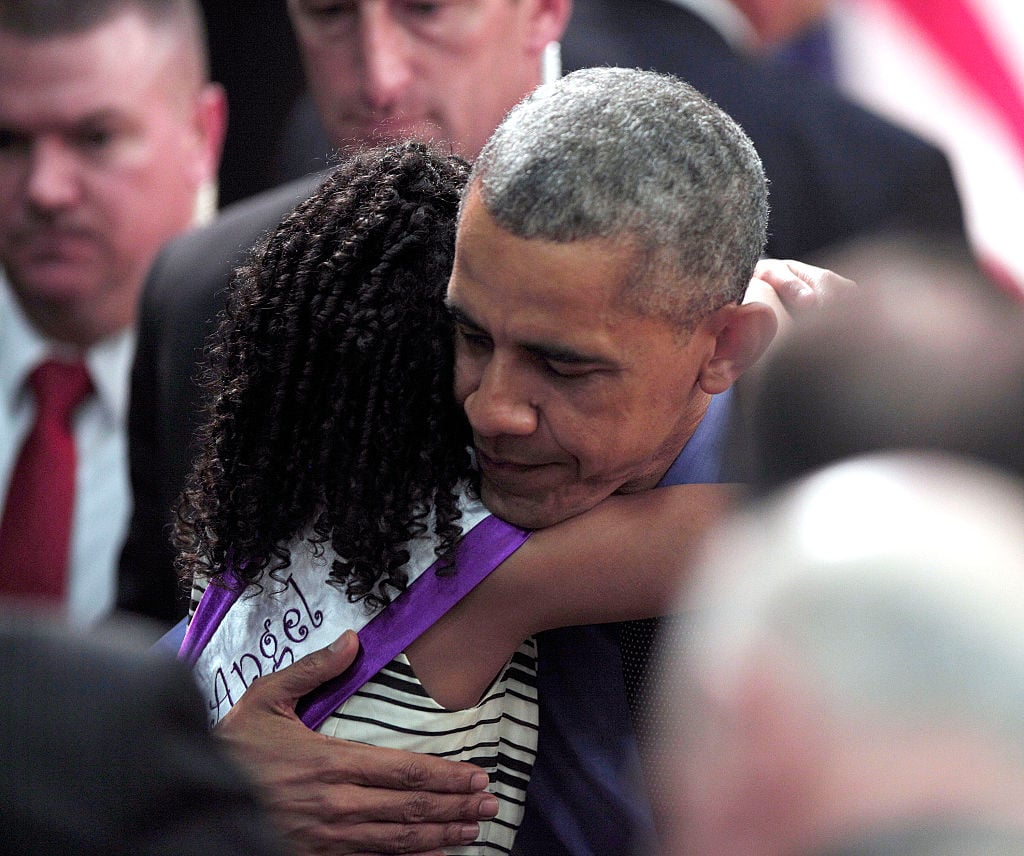 Obama comforts Flint victim