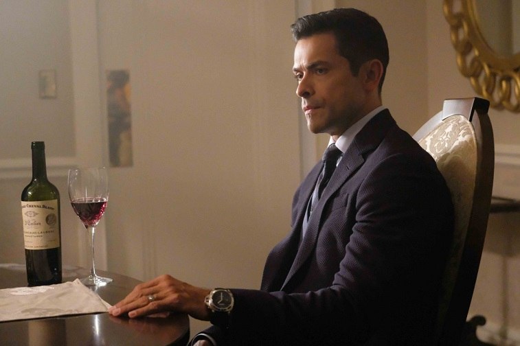 Mark Consuelos as Hiram Lodge sits at a table in front of a glass of wine in Riverdale