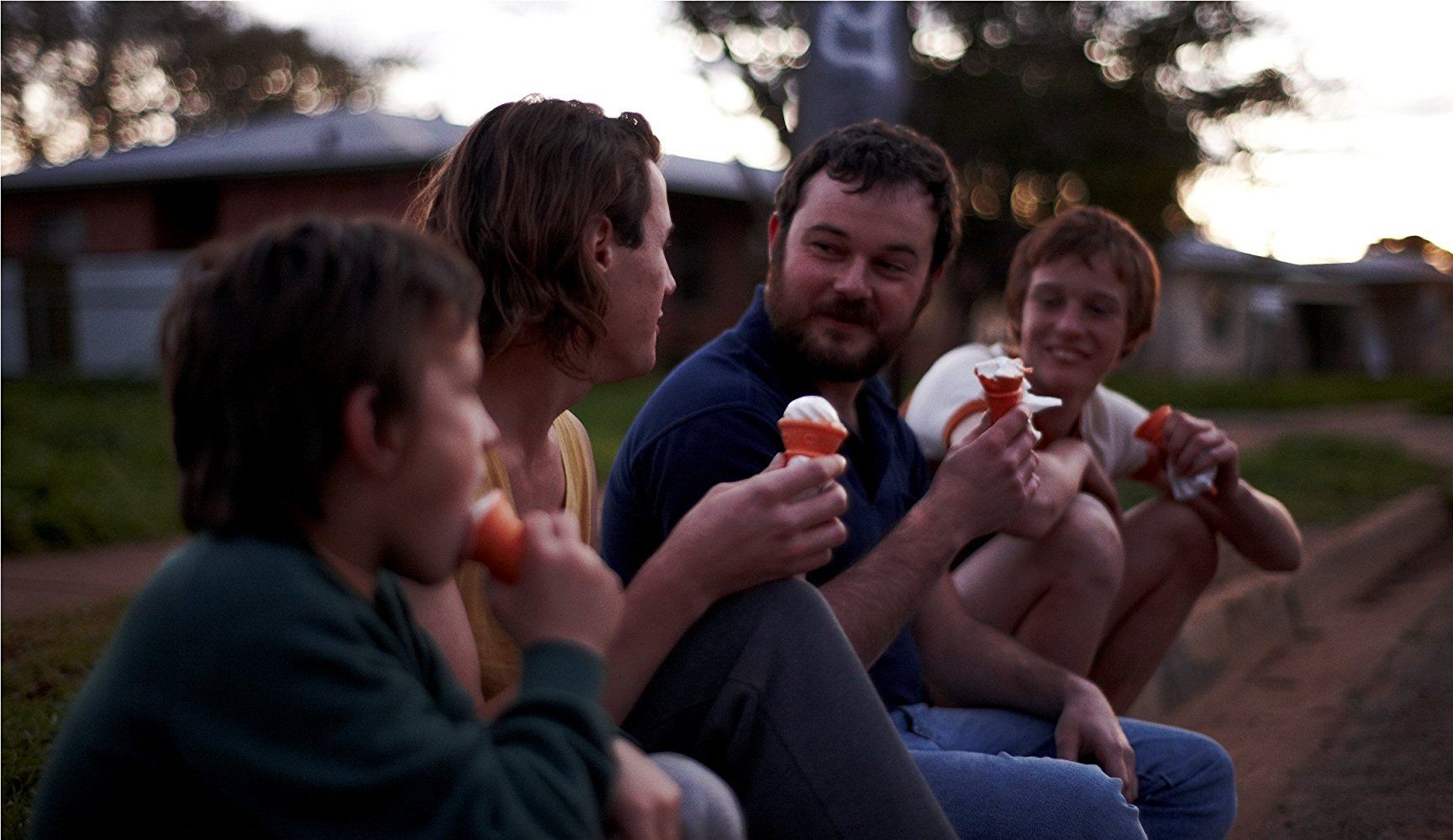 Daniel Henshall as John Bunting eating ice cream with three boys in Snowtown