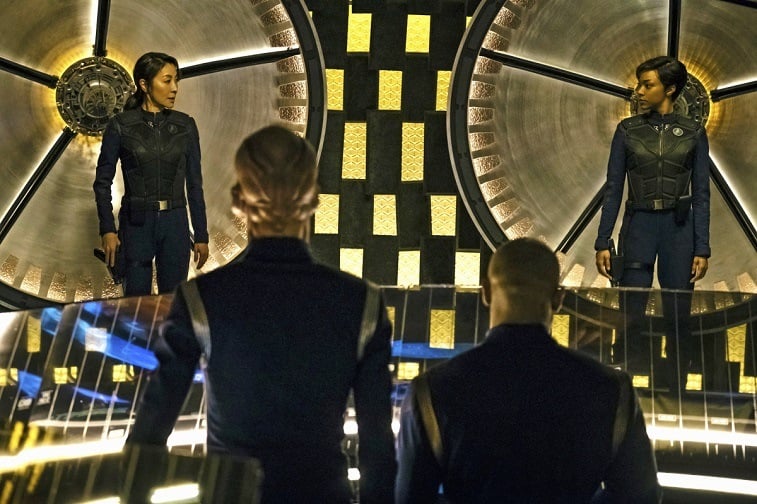 Two women look at each other in Star Trek: Discovery across the room from two men