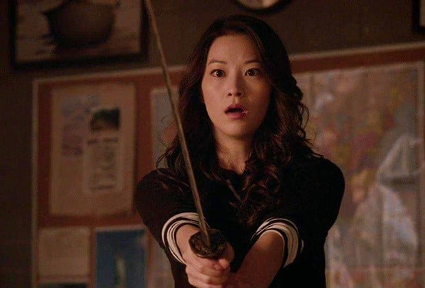 Arden Cho holds up a sword in Teen Wol